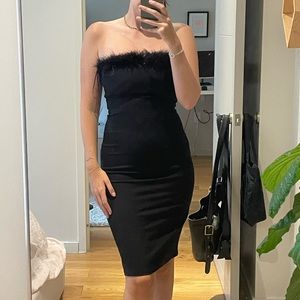 Black bodycon Reformation dress with feathers